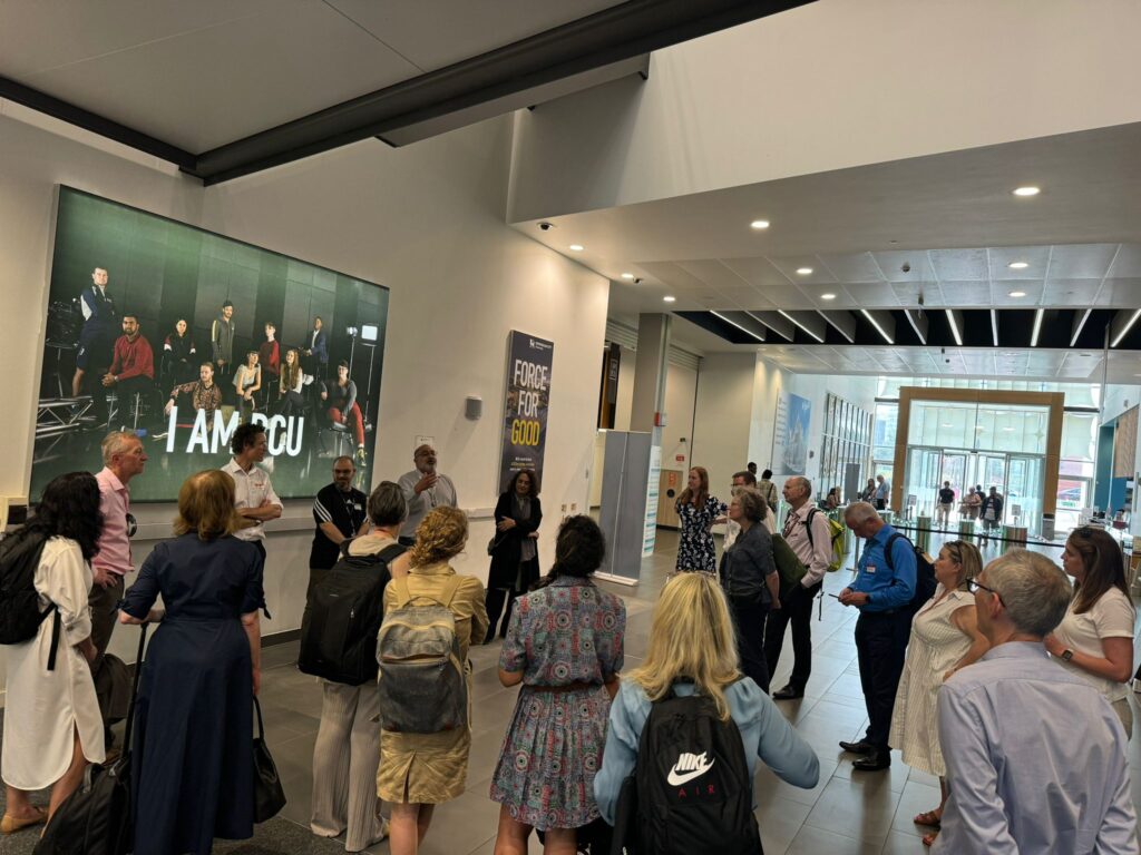 This image shows Birmingham City Council's corporate leadership team being welcomed by Birmingham City University partners at their campus in Curzon Building.